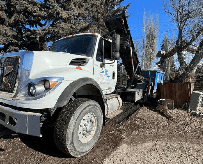 Professional dumpster delivery truck Red Deer Calgary Edmonton - CCT Bins bin placement Alberta service